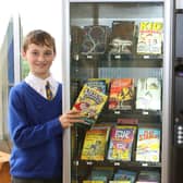 St Annes head boy Reuben Clay and head girl Grace Garner with the new book vending machine