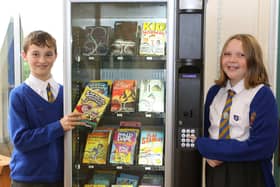 St Annes head boy Reuben Clay and head girl Grace Garner with the new book vending machine