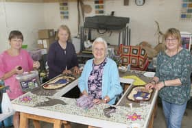 Whaley Bridge's well dressers at work on one of this week's displays, Toni Williams, Jill Malzard, Janet Brierley and Diane Beever. Pic Jason Chadwick