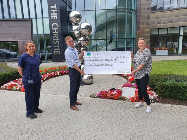 Gemma Ellis handing over the £10,000 cheque