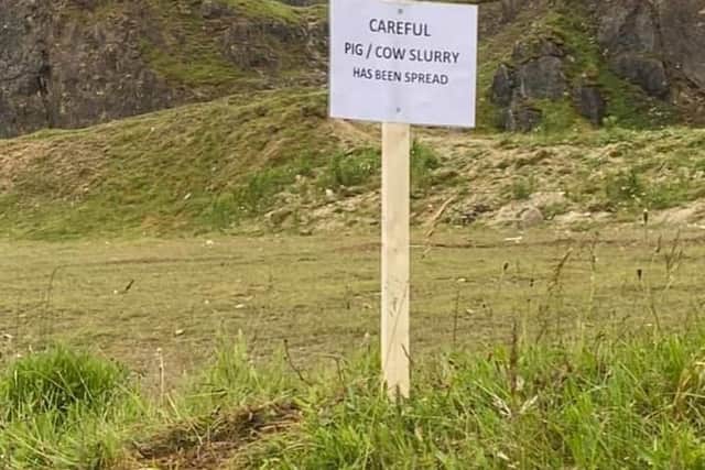 A sign at the site warns visitors about the muck