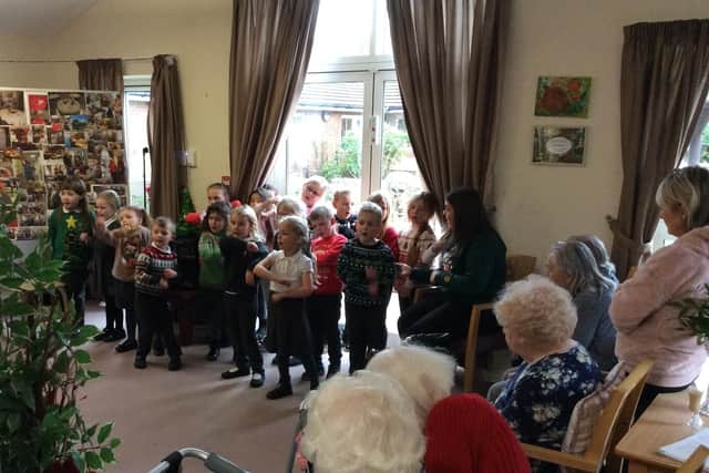 Pupils from Combs Infants sang carols and songs from their Christmas play to Eccles Fold and White Stones Care Home. Photo Combs Infants