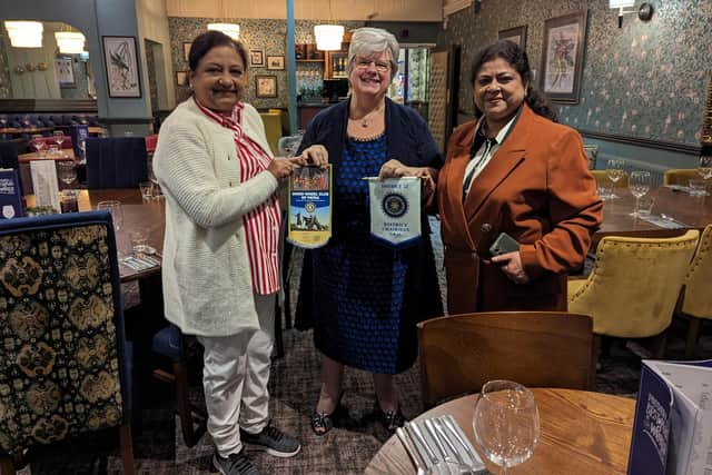 Pictured left to right, exchanging flags at the Inner Wheel get-together recently, are Poonam Agarwal, Lyn Cooper, 1st Vice Chairman, and Dr Neena exchanging flags.