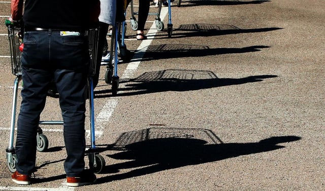 Shoppers queue using safe distance measures at Waitrose supermarket in Rushden, England (Photo: David Rogers/Getty Images)