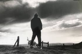 A man walking his dog on the Ringlow to Hathersage Road with Higger Tor to the right in the background - December 1977