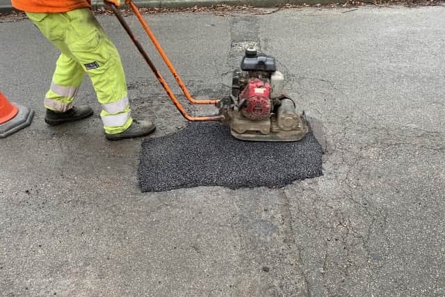 Pictured Is A Derbyshire County Council Worker Completing A Pothole Repair On One Of The County\'S Roads.