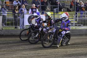 Alfie Bowtell of Buxton Bulls (in red) on the inside of Ryan Ingram of Leicester Lion Cubs (in yellow) and Bulls rider Jack Roberts (in blue) during the WSRA National Development League match between Buxton Bulls and Leicester Lion Cubs at Hi-Edge Speedway Photo: Ian Charles | MI News