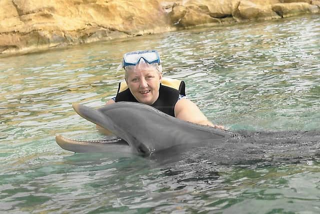 Linda fulfilling a life-long dream to swim with dolphins