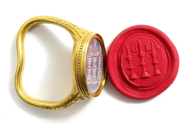 The gold seal ring features three candles and the initials GL. Photo:Hansons