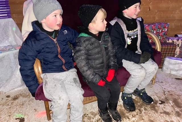 Youngsters waiting to meet the main man at a free grotto in the town to help families get festive without spending a fortune. Pic submit.