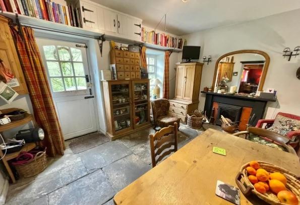 The dining room has a stable door, fireplace with cast iron stove and stone flagged flooring.
