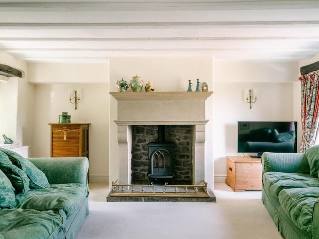 An elegant fireplace is the focal point of the sitting room.