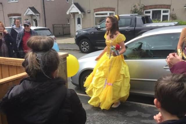 Isla is serenaded by Holly Howe as Belle from Beauty And The Beast