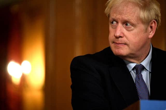 UK Prime Minister Boris Johnson looks on during a virtual press conference at Downing Street (Photo by Leon Neal/Getty Images)