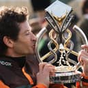 Amateur jockey Sam Waley-Cohen gives the trophy a kiss after winning last year's Grand National on 50/1 novice Noble Yeats in the last ride of his career.