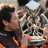 Amateur jockey Sam Waley-Cohen gives the trophy a kiss after winning last year's Grand National on 50/1 novice Noble Yeats in the last ride of his career.