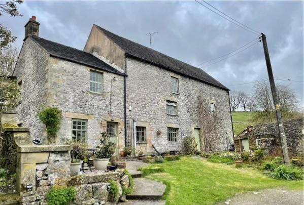 The two-bedroom home at Earl Sterndale represents about a third of the building and is attached to two uncoverted barns.