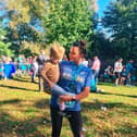 Sophie Elliott celebrates completing a previous race with her daughter Grace.