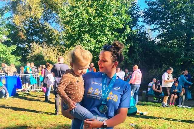 Sophie Elliott celebrates completing a previous race with her daughter Grace.