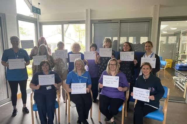 Blythe House clinical staff holding up signs showing their wishes for the end of their lives