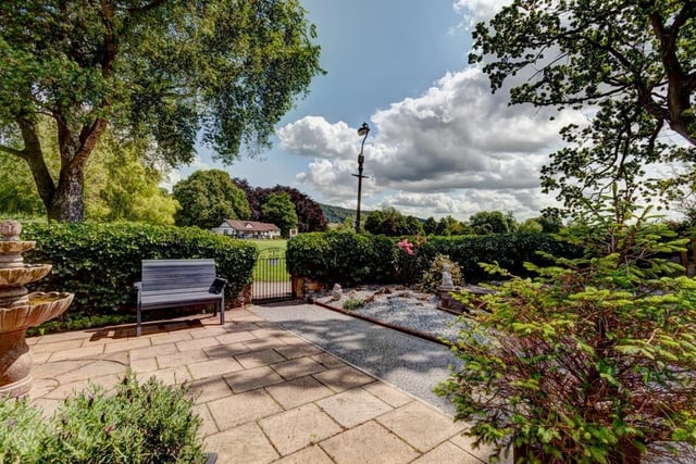 To the front of the property, there’s a stone patio with a water feature and an iron gate which opens to Bakewell Recreation Ground. The garden is bordered with stone walling and hedges.