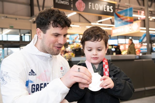 Team GB athlete Lewis Stewart, who cut the ribbon, let four year old Henry try his medal on. Photo Richard Grange/UNP (United National Photographers)