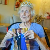 Marion Bould, a resident of Burton Closes Hall care home, Bakewell, with her 100th birthday card from King Charles.