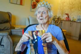 Marion Bould, a resident of Burton Closes Hall care home, Bakewell, with her 100th birthday card from King Charles.