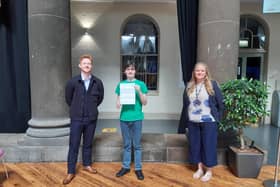 Morgan Wilkins receiving a grade 6 in his English Language GCSE from English tutor Joe Lawler and senior curriculum leader Alison Ivins.