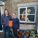 Chris Hollis and Shev Biggin outside their home in Chinley which is part of the community advent calendar