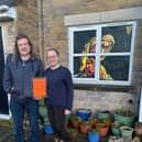 Chris Hollis and Shev Biggin outside their home in Chinley which is part of the community advent calendar