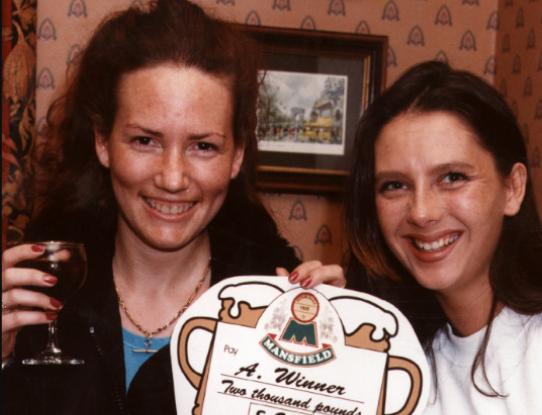 Sarah Burdon, left, of Doncaster, with a £2,000 winners cheque from Michelle Wong at the Alverley Pub, Springwell Lane in 1997