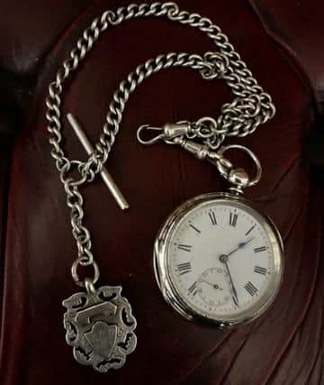 Silver pocket watch, silver fob, and silver albert chain found at Melissa and Mark’s scrapyard