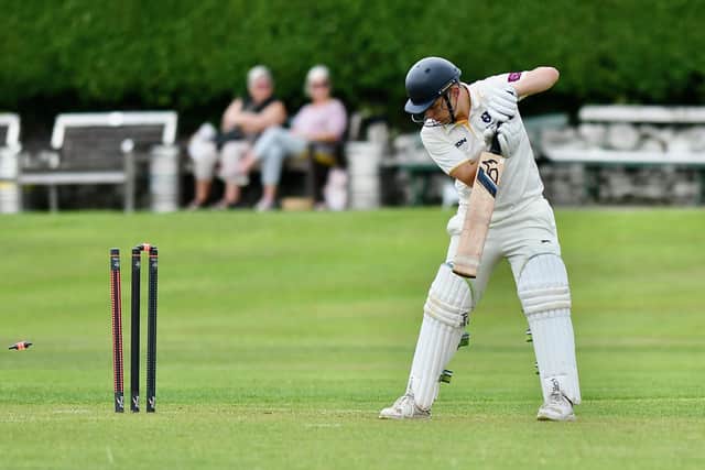 Kai Harman of New Mills is bowled out by Dove Holes' Dan Gilbride. Picture by John Fryer.