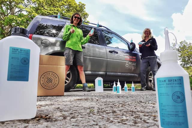 Peak District National Park rangers with hand sanitiser from White Peak Distillery.