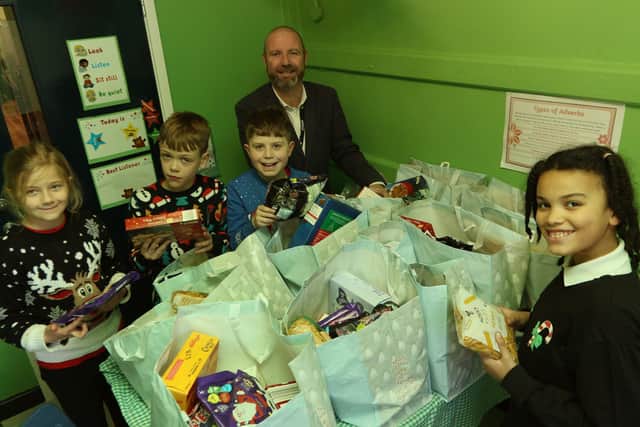 Buxworth Primary Christmas collection, Head Paul Bertram with Clara, Sam, Charlie and Mirabelle making up hampers.