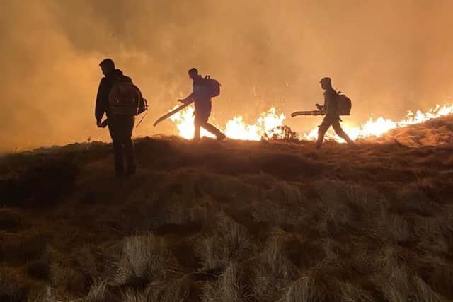 This photo shows firefighters as they battle a Peak District wildfire in April 2021.