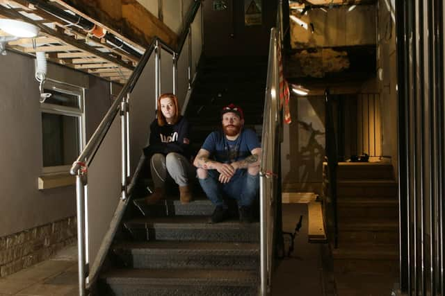 Karl Gregory and Alice Statham in the communal area of the flats