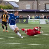 Ben Sault slides home Buxton's winner in stoppage time. Photo: Phil Peat Photography.