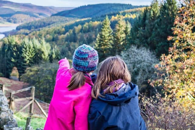 Two young people look out across the Peak District National Park from Lockerbrook Farm centre 