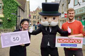 Stacey Barrett from Bakewell tart shop, Mr Monopoly and John Keen-Tomlinson of Winning Moves UK the launch of the Peak District edition game.