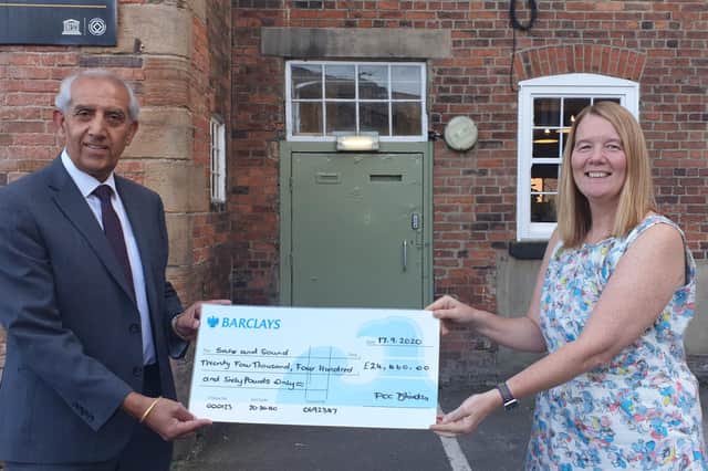 Hardyal Dhindsa presents a cheque to Tracy Harrison, chief executive of the  Safe and Sound charity that works to protect children at risk of exploitation including sexual, trafficking and modern slavery.