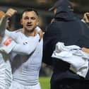 Diego de Girolamo (centre) is mobbed after scoring the winner for Buxton at York in the FA Cup. Photo: Richard Parkes.