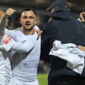 Diego de Girolamo (centre) is mobbed after scoring the winner for Buxton at York in the FA Cup. Photo: Richard Parkes.