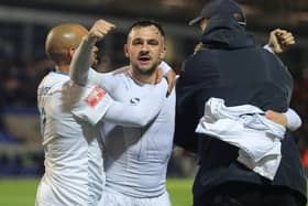Diego de Girolamo (centre) is mobbed after scoring the winner for Buxton at York in the FA Cup. Photo: Richard Parkes.