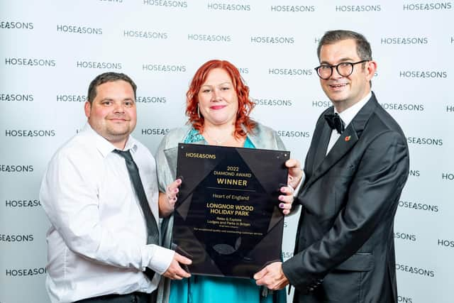 Ian and Samantha Kitchen, of the Longnor Wood Holiday Park team, received the award from Awaze vice-president Paul Evans, right.