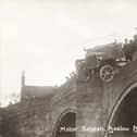 Baslow Bridge, 1915. A motor bus (Charabanc) accident, showing the bus balanced precariously over the parapet. Note that the vehicle has solid rubber tyres. The spectators are presumably the charabanc's passengers who have had a lucky escape. The stone bridge with cutwaters probably dates from the 17th century.  (Photo by NEMPR Picture the Past/Heritage Images/Getty Images)