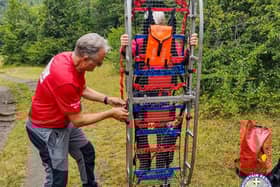 The injured hiker was placed onto a mountain rescue stretcher.