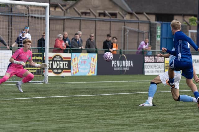 Luke Brennan scores against Manchester City. Photo: Phil Peat.