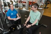 An instructor looking after someone in the gym